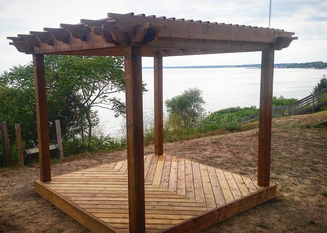 Cedar timber-frame pergola over a waterfront deck